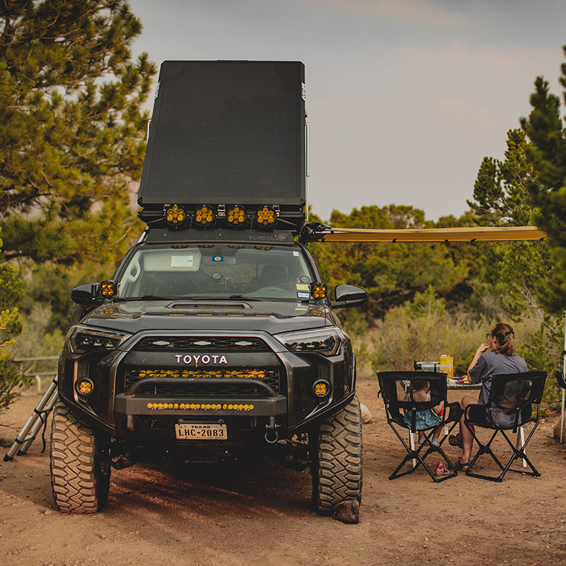 black 4runner with rooftop tent in forest