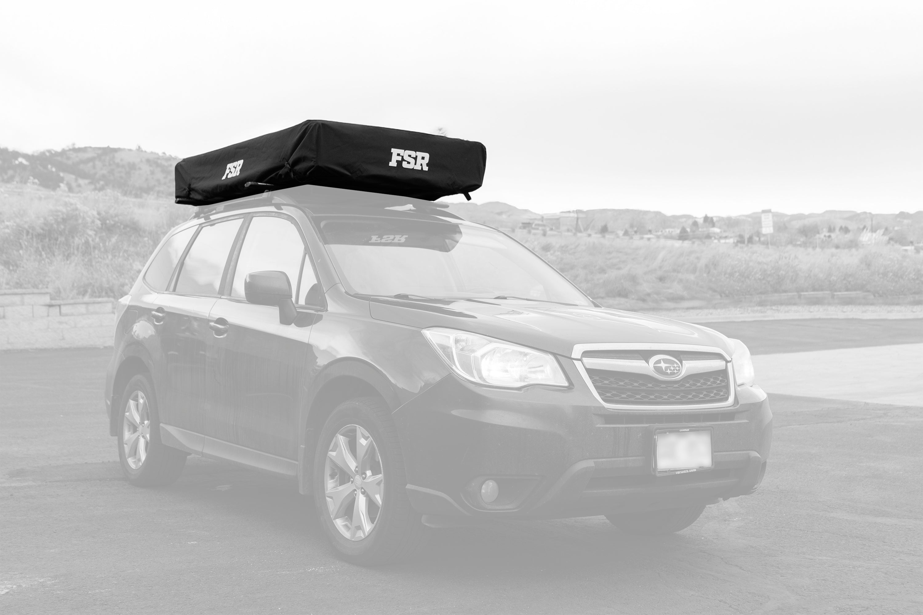 Car with a roof rack on a blurred background