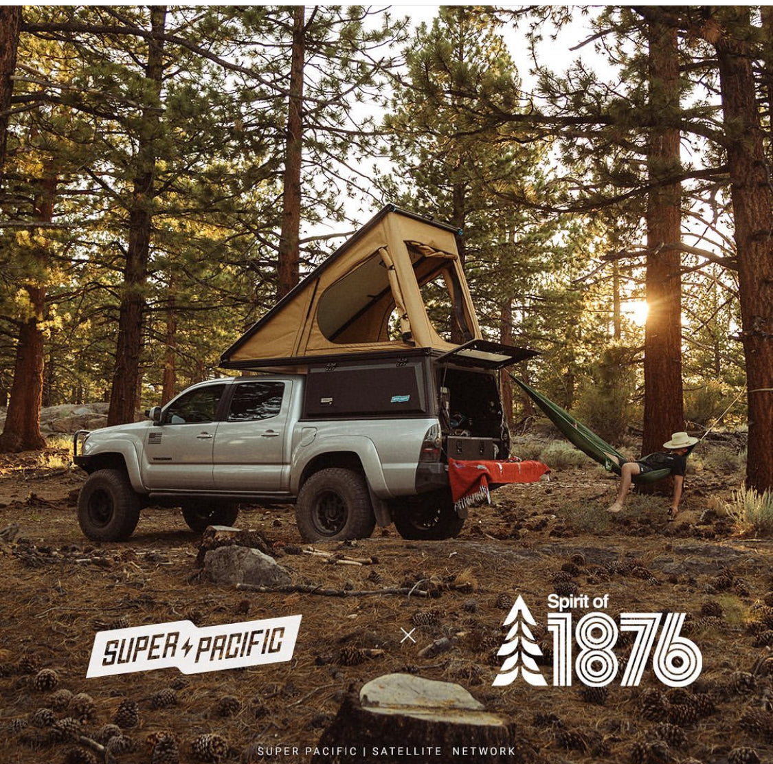 Super Pacific and Spirit of 1876 truck topper in forest with rooftop tent open