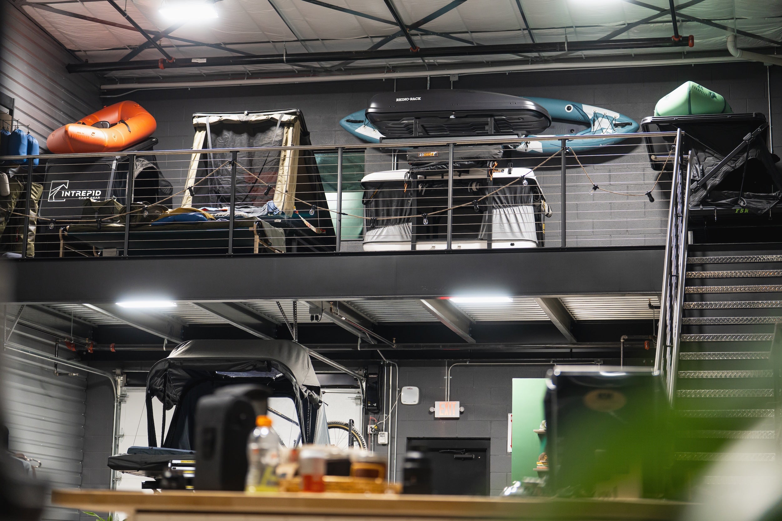 showroom for rooftop tents 4 tents and a kayak on display