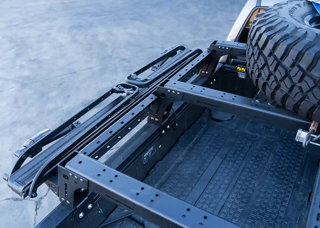 Truck bed with a metal frame and tire on a snowy background