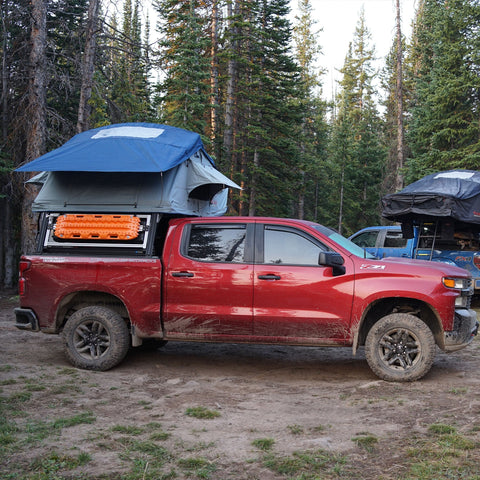 Chevrolet Silverado Xtrusion Overland Bed Rack with traction boards, and Roam roof top tent set up.