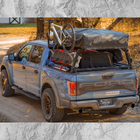 Ford Raptor Extrusion Overland Bed Rack with Hi-lift mounted, Rotopaxâ€™s mounted, Molle panels, Mountain Bike, Roof top tent, and Pressurized solar water tank.